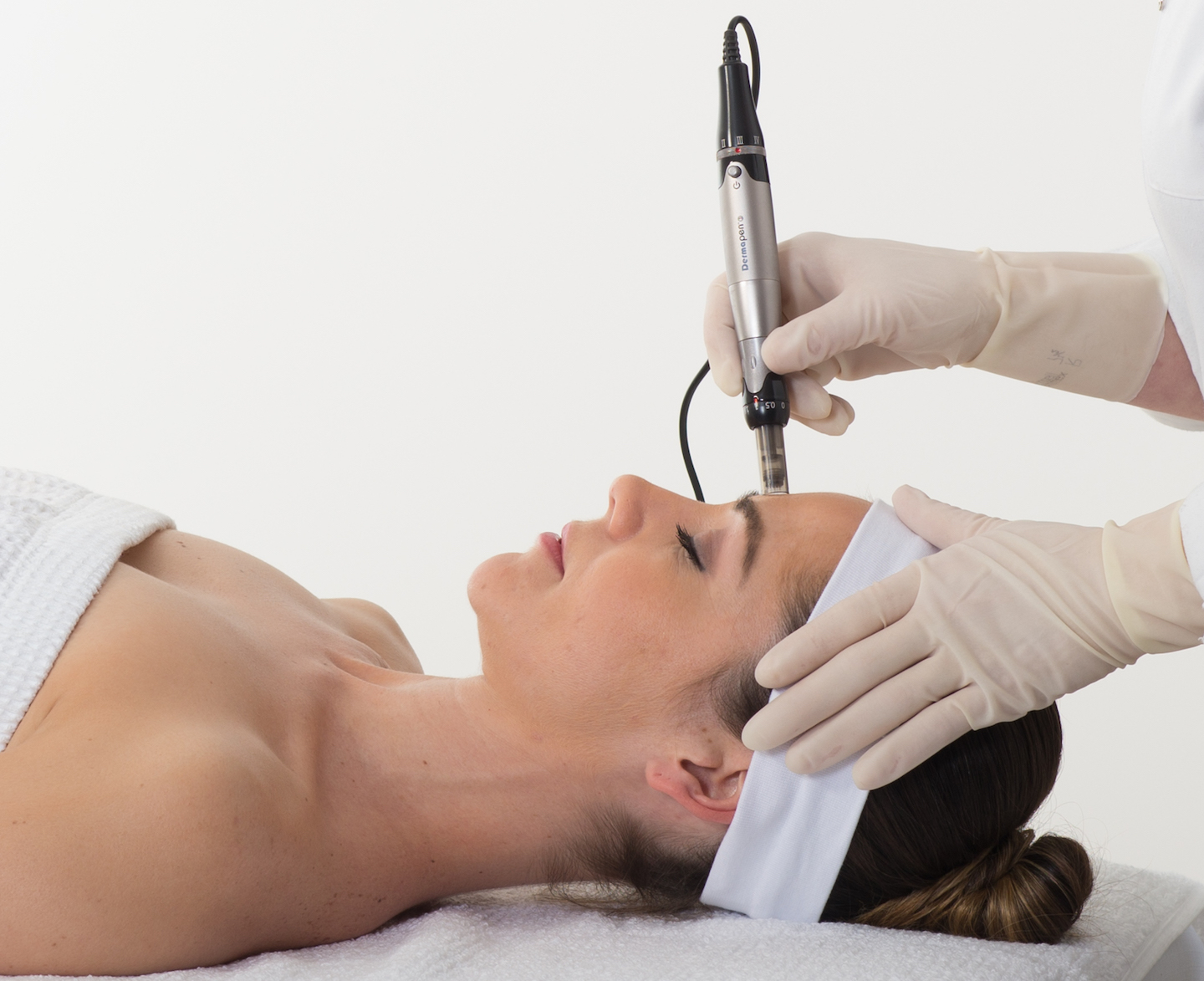 Woman patient receiving Dermapen micro needling treatment for facial aesthetics
